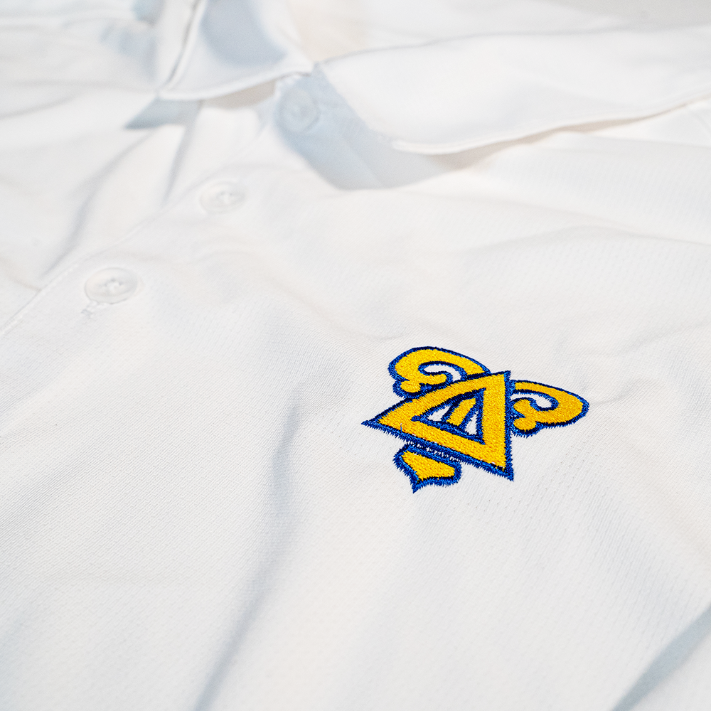 
                      
                        Delta Upsilon Badge Piqué Performance Polo in White
                      
                    